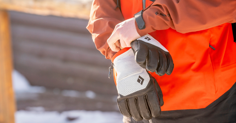 Mężczyzna zapina rękawice narciarskie marki Black Diamond