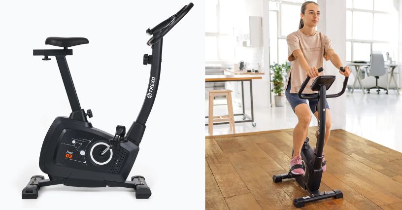 Kobieta w stroju sportowym jadąca na rowerze stacjonarnym TREXO Hex 02 w pokoju