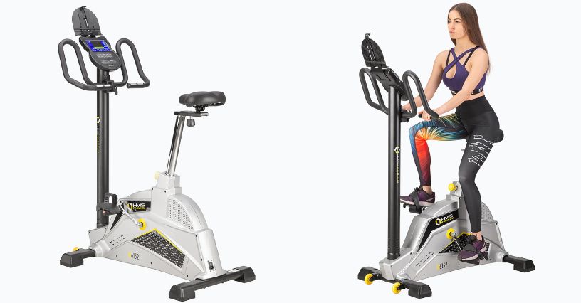 Kobieta w stroju sportowym jadąca na elektromagnetycznym rowerze stacjonarnym HMS Premium M6152 17-01-042