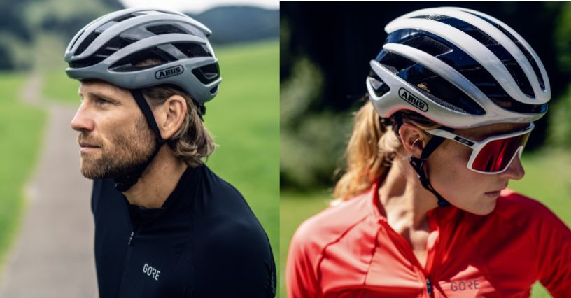 Kobieta i mężczyzna w odzieży sportowej noszący kaski rowerowe ABUS AirBreaker 2.0