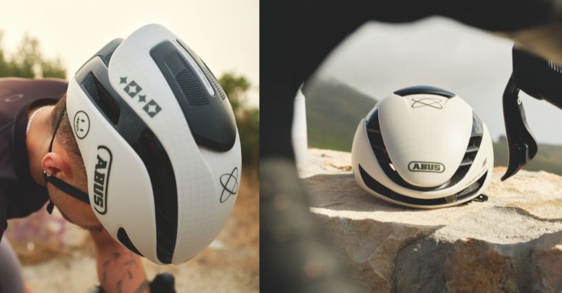 Kask szosowy ABUS GameChanger 2.0 na głowie profesjonalnego kolarza i położony na skale
