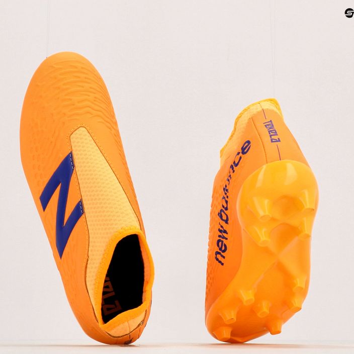 Buty piłkarskie dziecięce New Balance Tekela V3+ Magique JNR FG impulse/vibrant orange 10